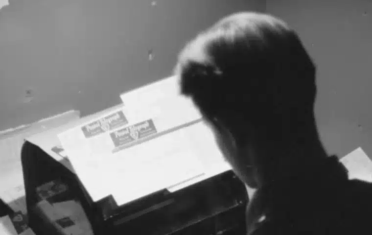 Person typing on a typewriter, representing developer workflows and code generation.