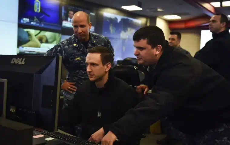 Operations team monitoring multiple screens in a control center